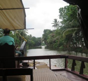 Our captain steering up a narrow channel in the backwaters of India’s Kerala state. Photo by John Fleckles